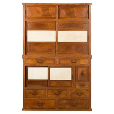 an old wooden cabinet with many drawers and mirrors on it's sides, against a white background