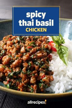 spicy thai basil chicken with white rice in a blue bowl on top of a table