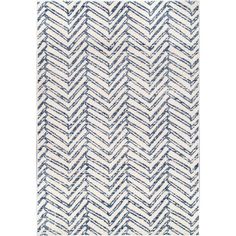 a rug with blue and white chevroned lines on it, in the shape of a zigzag pattern