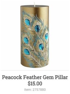 a blue and gold candle holder with peacock feathers on it