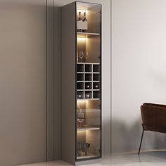 a tall cabinet with wine glasses on it in a living room next to a chair