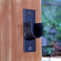 a black door handle on a wooden door