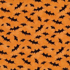 an orange background with black bats on it