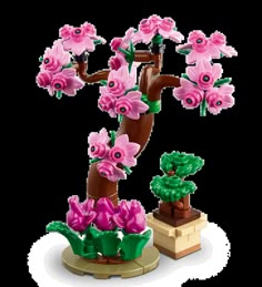 a lego tree with pink flowers on it and two small trees next to it, all in the same color