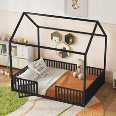 a child's bed with a black frame and canopy