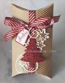 a christmas card with a red and white ribbon tied around the front of it,