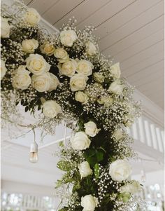 white roses and baby's breath hanging from the ceiling