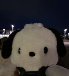 a close up of a stuffed animal with lights in the background