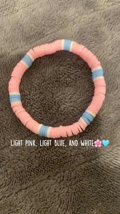 a pink, blue and white bracelet with words on it that read light pink, light blue, and white