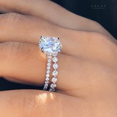 a woman's hand with a diamond ring on it