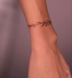 a woman's arm with a small tattoo on it