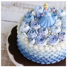 there is a cake decorated with blue and white frosting on the top of it