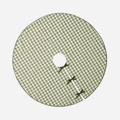 a green and white checkered pattern on a cd disc with two holes in the middle