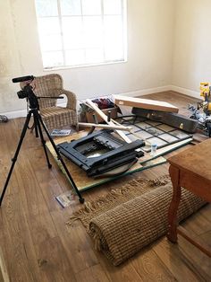 a camera is set up on the floor in front of a table with construction materials