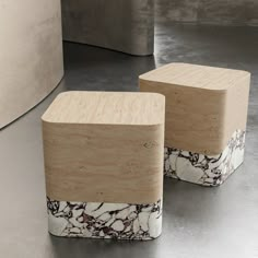 two wooden stools sitting next to each other on top of a metal flooring