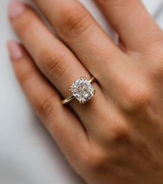 a woman's hand with a diamond ring on it