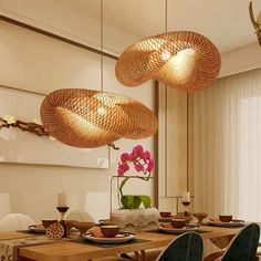 a dining room table with plates and bowls on it, hanging from the ceiling above