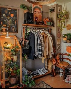 a room filled with lots of clothes and plants