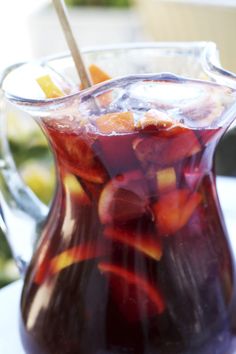 a pitcher filled with liquid sitting on top of a table