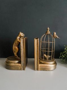 two golden figurines are sitting next to each other