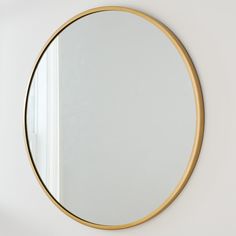 a round mirror hanging on the wall