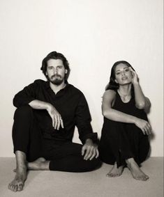 a man and woman sitting on the floor next to each other