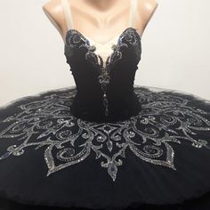 a mannequin wearing a black dress with silver sequins