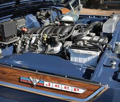 the engine compartment of a blue car with its hood open