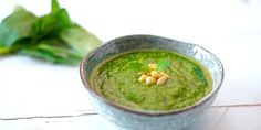 a small bowl filled with green soup and garnish