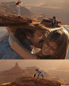 two people standing on top of a cliff with mountains in the background and one person holding his head