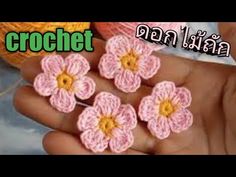 small crochet flowers are being held in someone's hand with the words crochet written on it