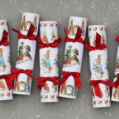 several rolls of wrapping paper wrapped in red ribbon and decorated with images of animals on them