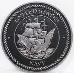 the united states navy logo is shown on a black and silver plated metal coin