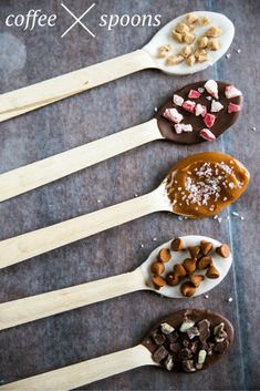 spoons filled with different kinds of food on top of a table