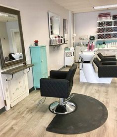 a hair salon with chairs and mirrors