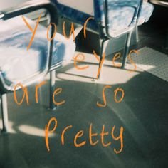 there are some chairs that have been painted orange and blue with the words you've eyes, one so pretty