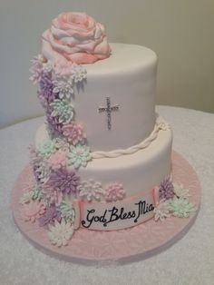 a cake decorated with flowers and a cross