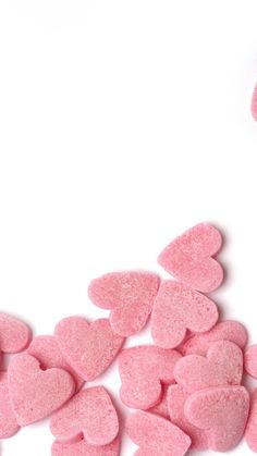 pink heart shaped candies on white background