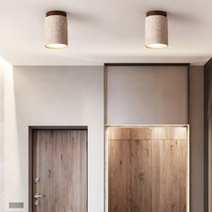 two wooden doors in a room with white walls