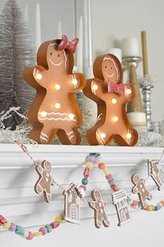 two gingerbread mantels on top of a mantle