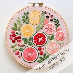 an embroidery pattern with fruit and leaves on it