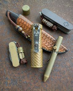 several different types of knives and lighters laying on the ground next to each other