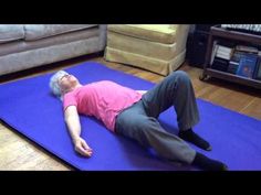 an older man laying on a yoga mat