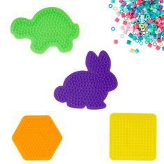 three different shapes of plastic beads and some colored sprinkles on a white surface