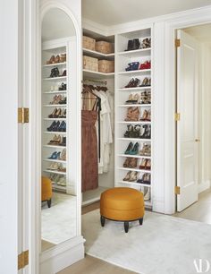 a walk in closet filled with lots of shoes