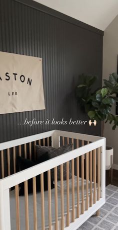 a baby crib in a room with a sign hanging on the wall above it