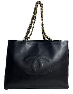 Chanel Vintage Black Leather CC Logo Tote Bag.  Features leather laced chain straps.  Made In: France Year of Production: 1994-1996 Color: Black Hardware: Goldtone Materials: Smooth lambskin leather Lining: Leather Closure/Opening: Open top  Interior Pockets: One zip Exterior Condition: Very good condition with some wear throughout Interior Condition: Very good  Measurements: 16"W 12"H x 4"D Handle Drop: 4" Strap Drop: 11" PLEASE NOTE: We will ship this item out fully insured, with signature required upon delivery.   A Second Chance is a family owned and operated luxury consignment and resale business located in NYC. We have been in business since 1993 and stand behind everything we sell with a 100% authenticity guarantee, or your money back. Selling only authentic pre-loved items has been Resale Business, Logo Tote Bag, Chanel Vintage, Cc Logo, Second Chance, Black Hardware, Vintage Chanel, Open Top, Lambskin Leather