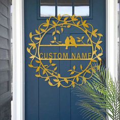 a blue front door with a yellow bird on it and the words, custom name