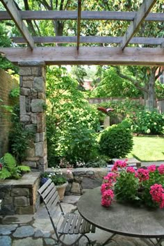 an outdoor patio with flowers on the table