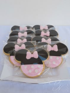 mickey and minnie mouse cupcakes in plastic wrappers on top of a table